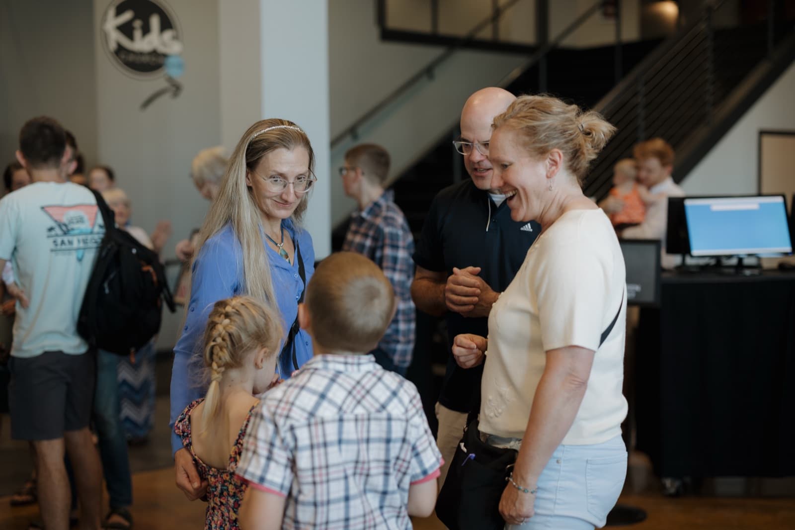 Families connecting in the lobby at Pleasant Valley.