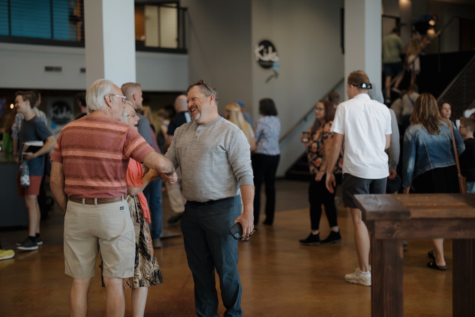 People greeting one another in the lobby.